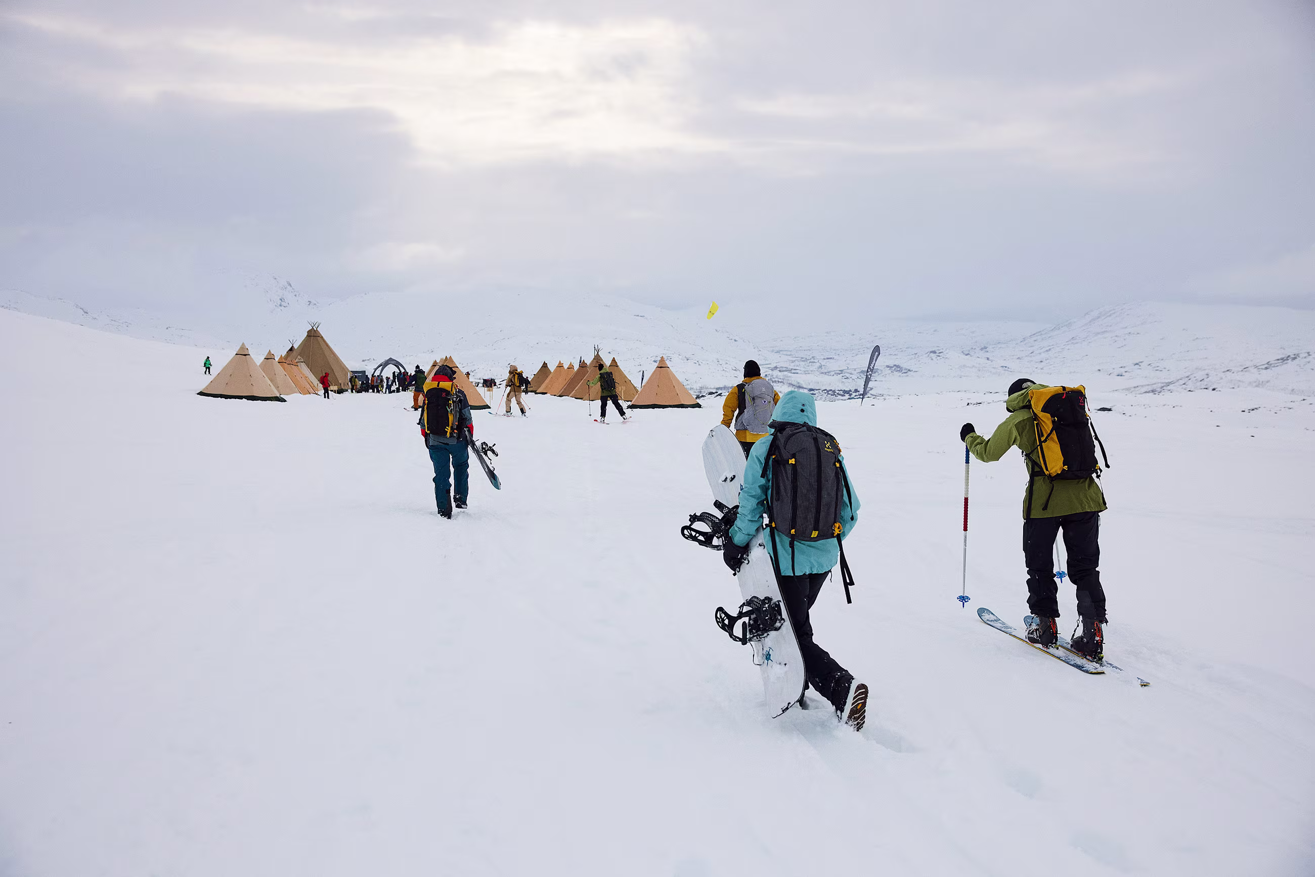 Haglöfs vassi Camp, people heading to the camp with ski and snowboard gear 