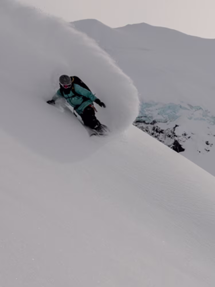 Tailer Gray Spinney snowboarding down a mountain