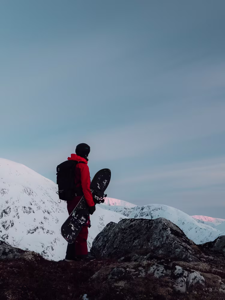 Henna Palosaari snowboarding down a mountain