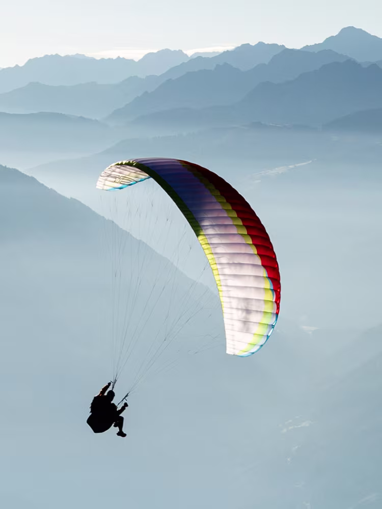 Roman Rohrmoser flying over mountains