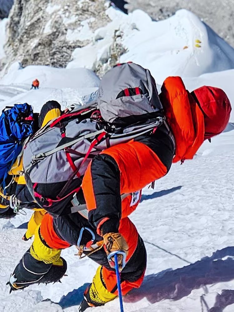 Oskar Normelli climbing a snowy mountain