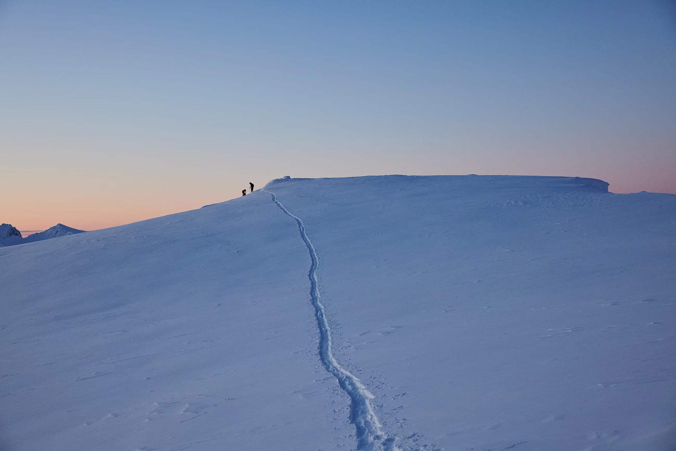 People touring in the mountains in the dawn