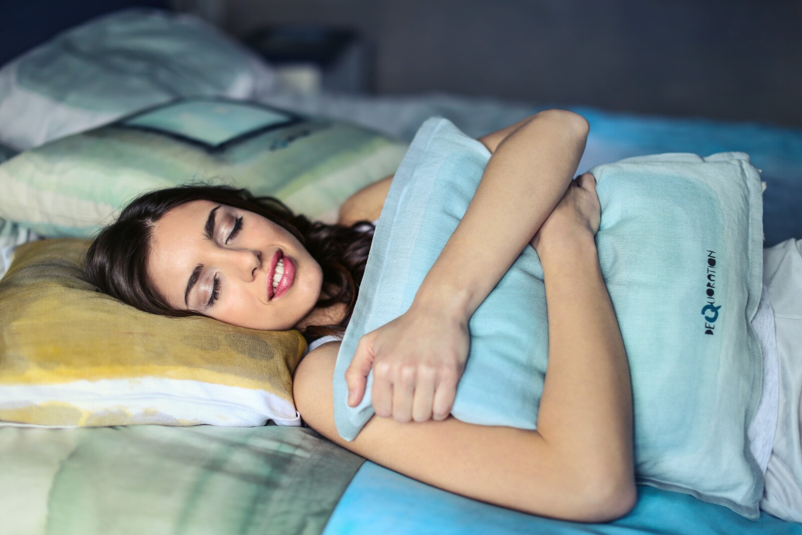 woman sleeping hugging a pillow 