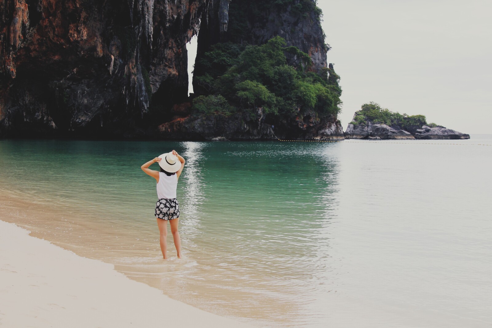 a woman walking on the beach 