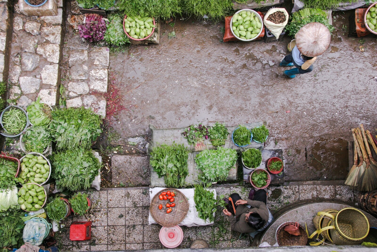 aerial view of a dirt and stone road where there are many herbs in baskets 