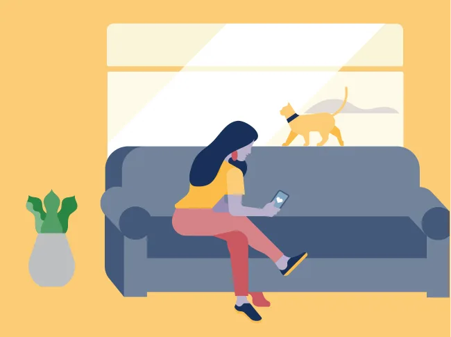 a woman sitting on a couch with a dog in the background.