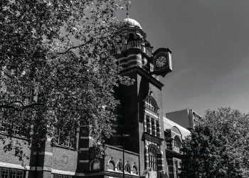 Building photo of Bayes Business School showing a black and white photo of a building with a clock tower