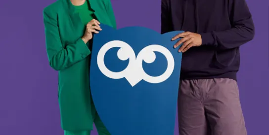 Two people holding the Hootsuite owl logo.