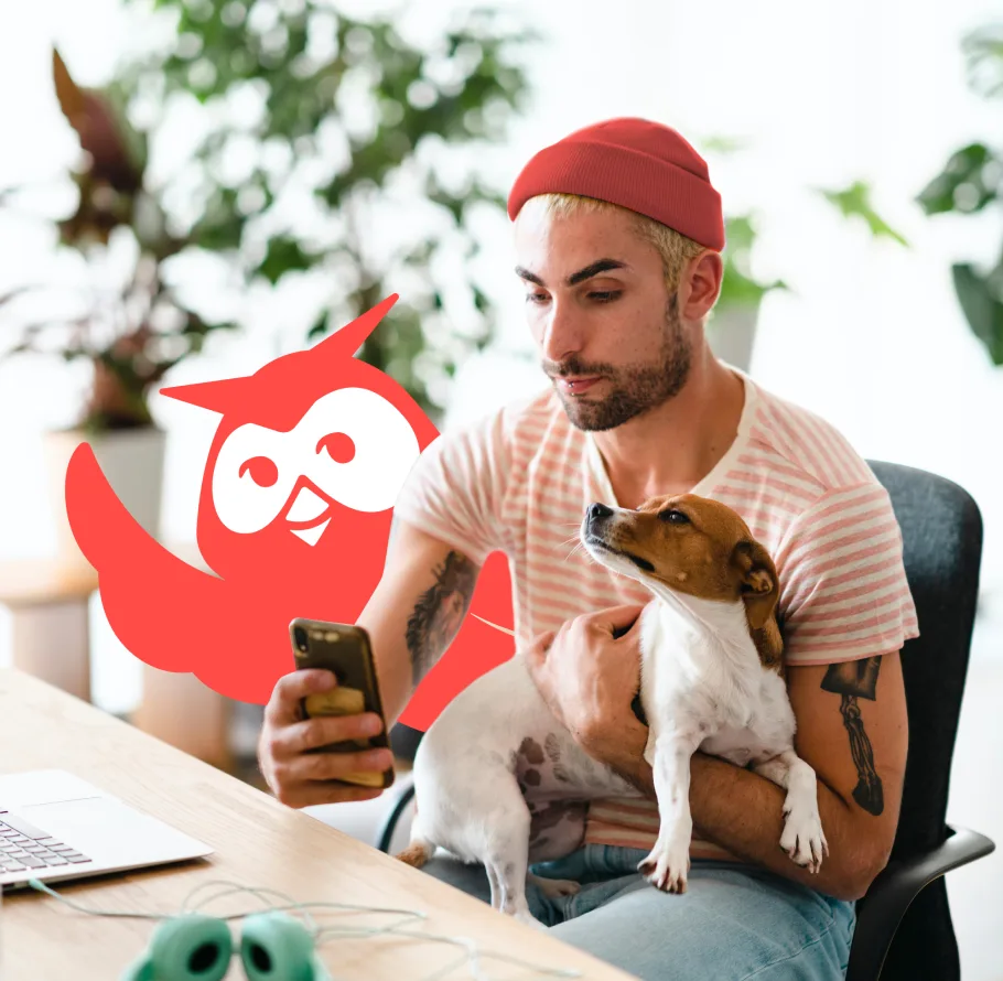 Image of person holding phone with dog and Owly