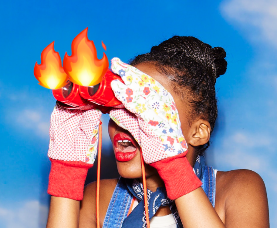 Person looking through binoculars with flames coming out of them