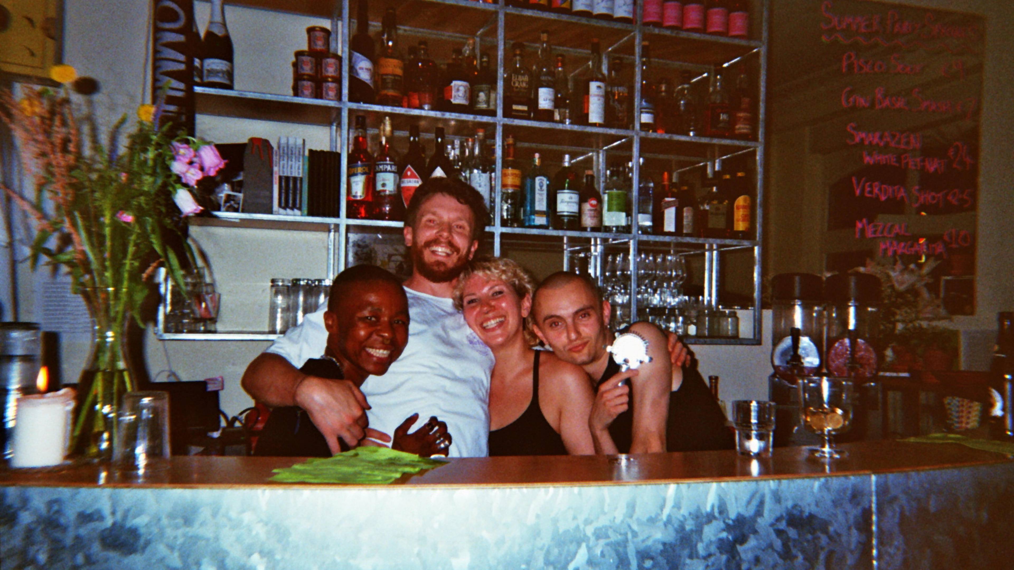 Members of Oona stand together behind the bar.