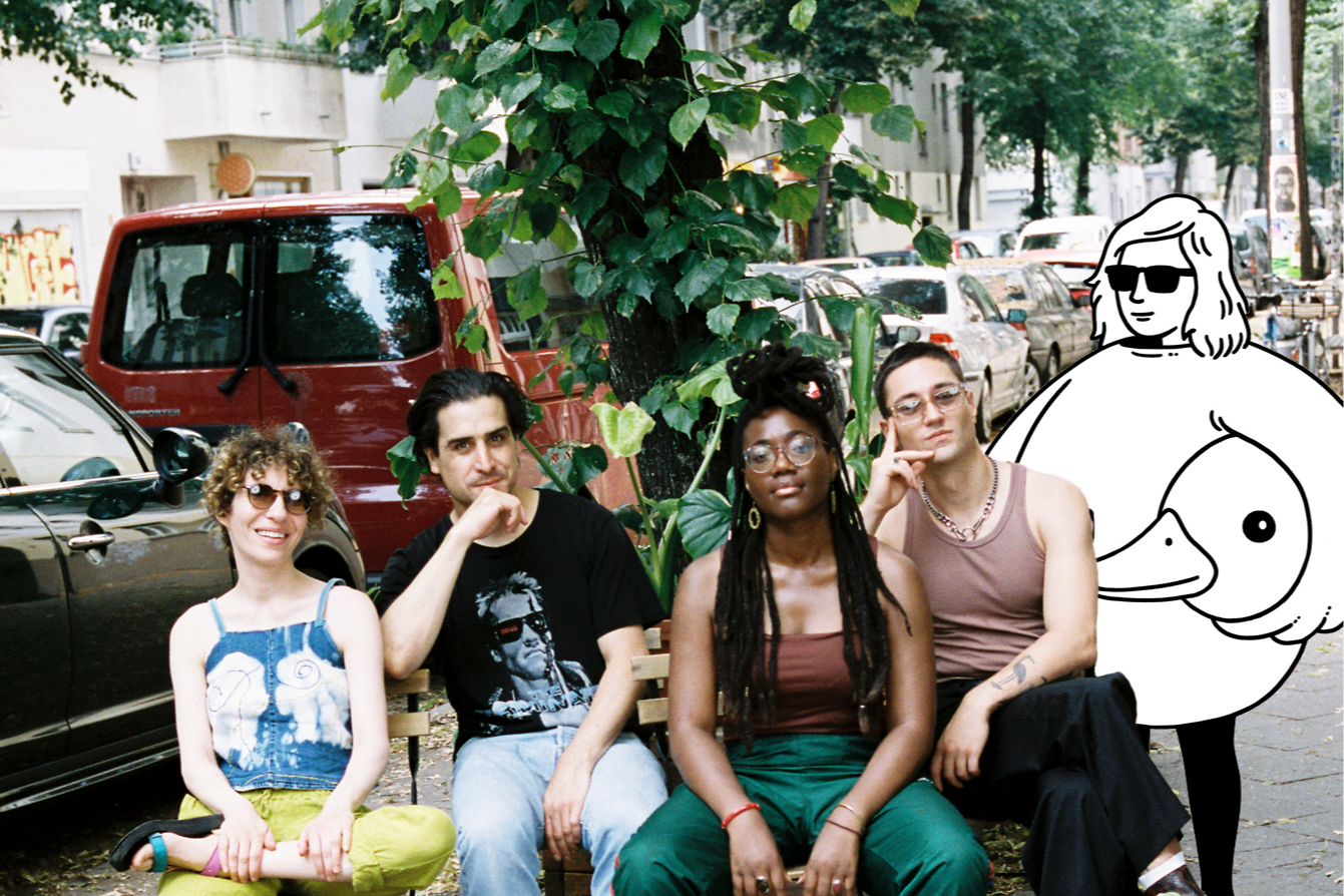 The four breakfast show hosts sit on  weserstraße alongside a minor figures cartoon character.