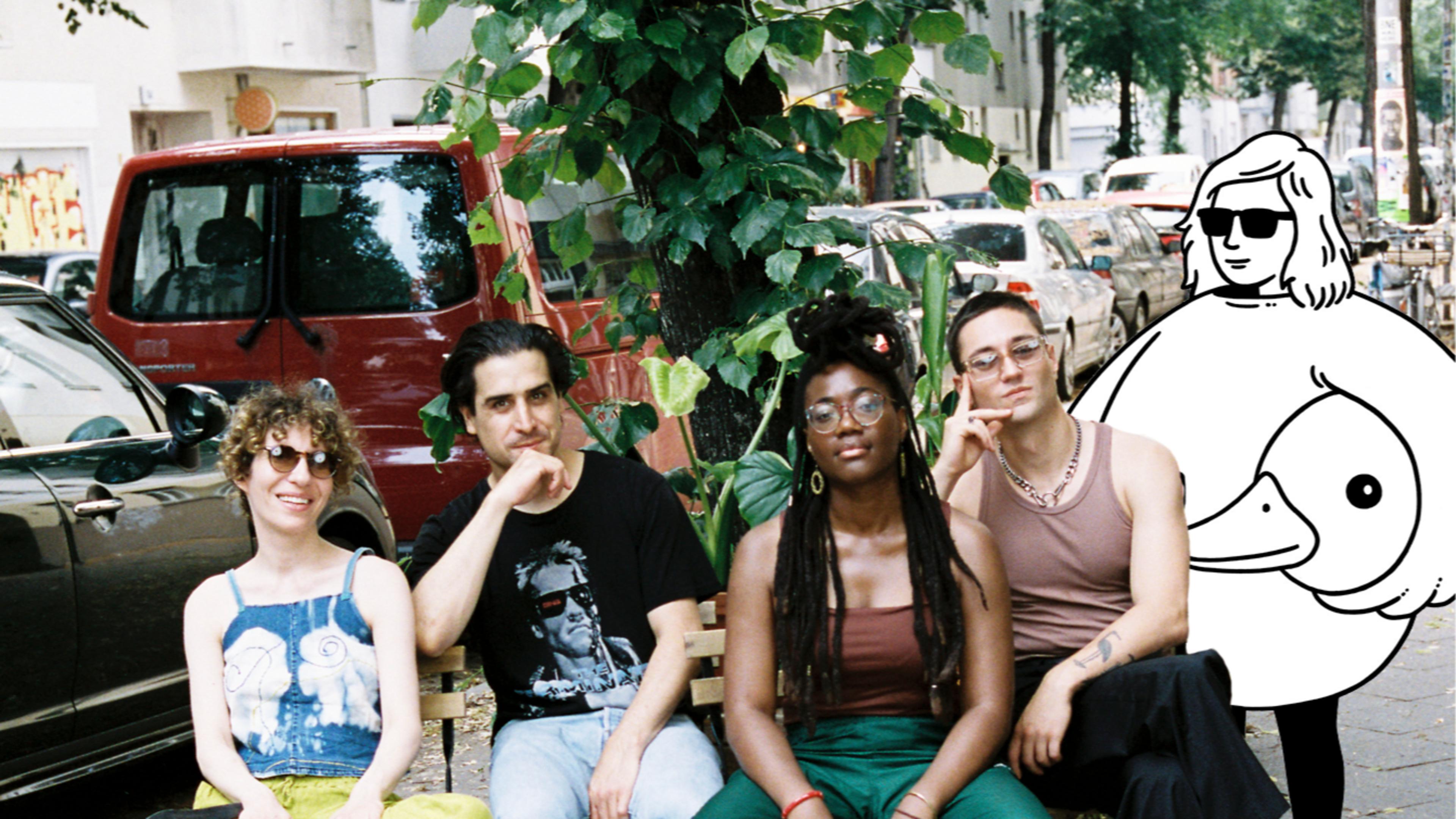 The four breakfast show hosts sit on weserstraße alongside a minor figures cartoon character.