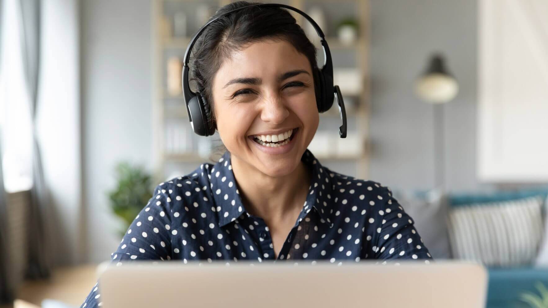 woman with headset in front of laptop using SIP and VoIP