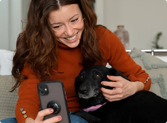 Woman with dog holding a phone