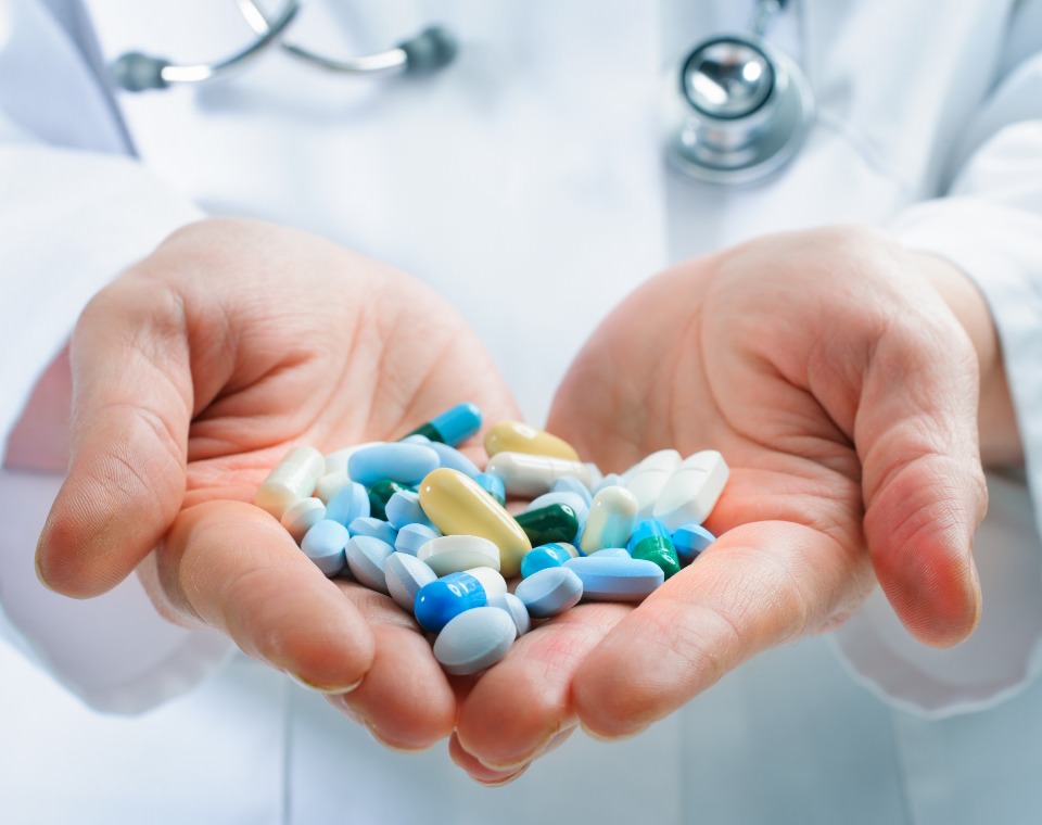 doctor holding pills iscreen