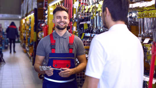 Image of en engaged hardware store employee helping a customer