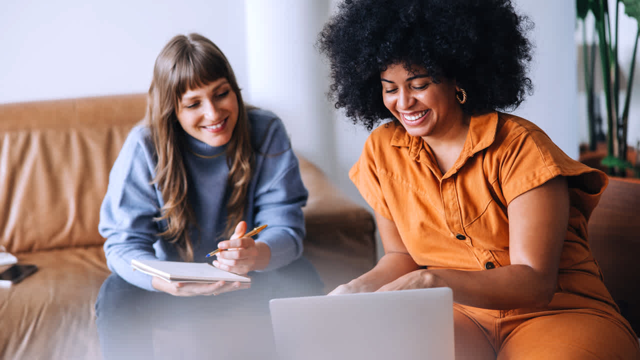 Image of two women working together on the computer