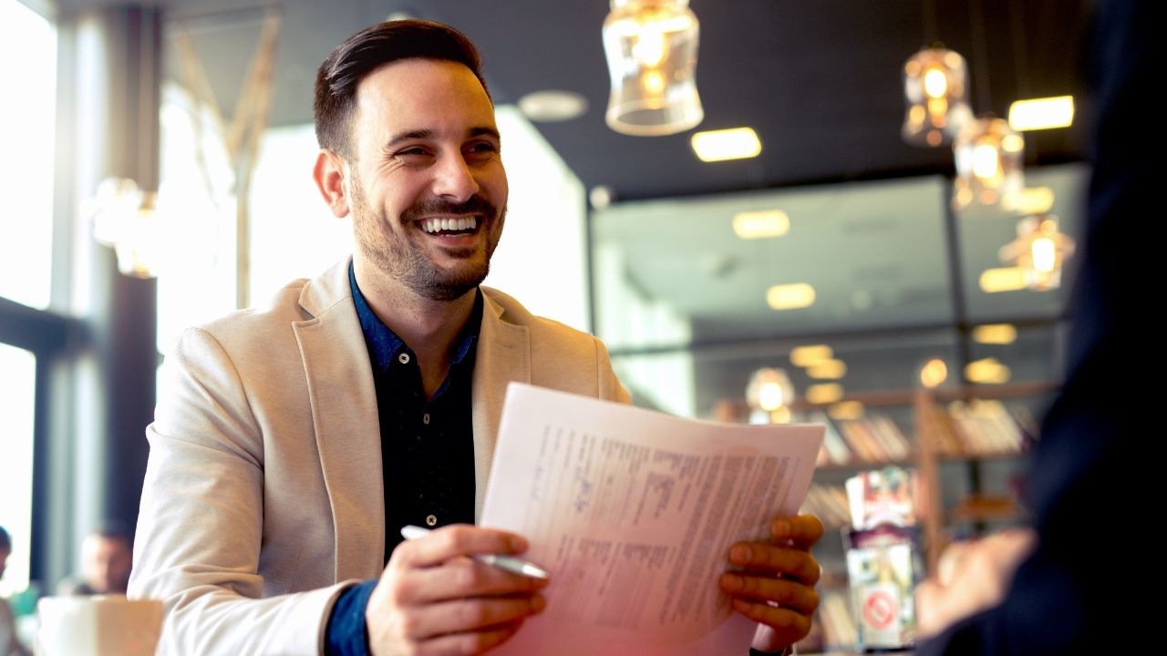 Smiling man with papers 