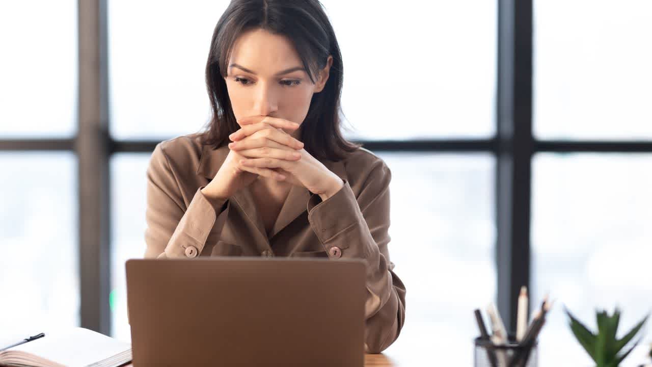 Woman with laptop thinking