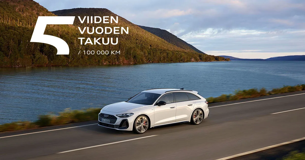 Valkoinen Audi Avant ajaa järven vieressä.