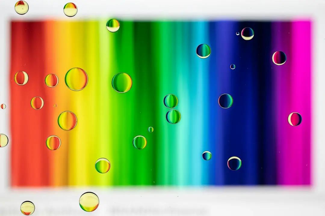 a rainbow colored background with water droplets