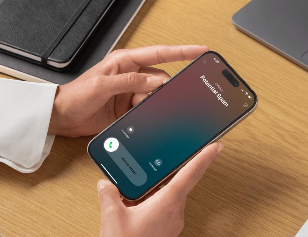iPhone displaying an incoming call labeled ‘Potential Spam.