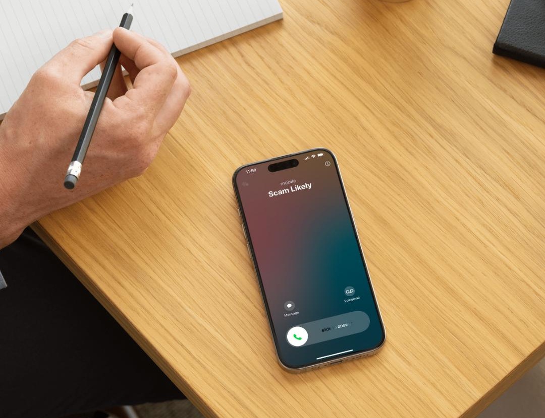 Smartphone showing an incoming call labeled 'Scam Likely