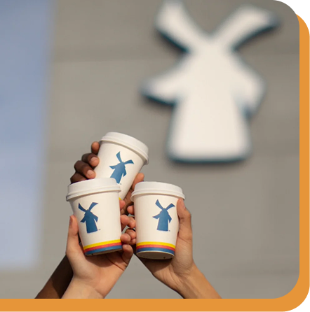 3 coffees cheersing in front of dutch bros