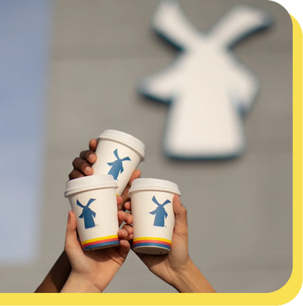 3 coffees cheersing in front of dutch bros