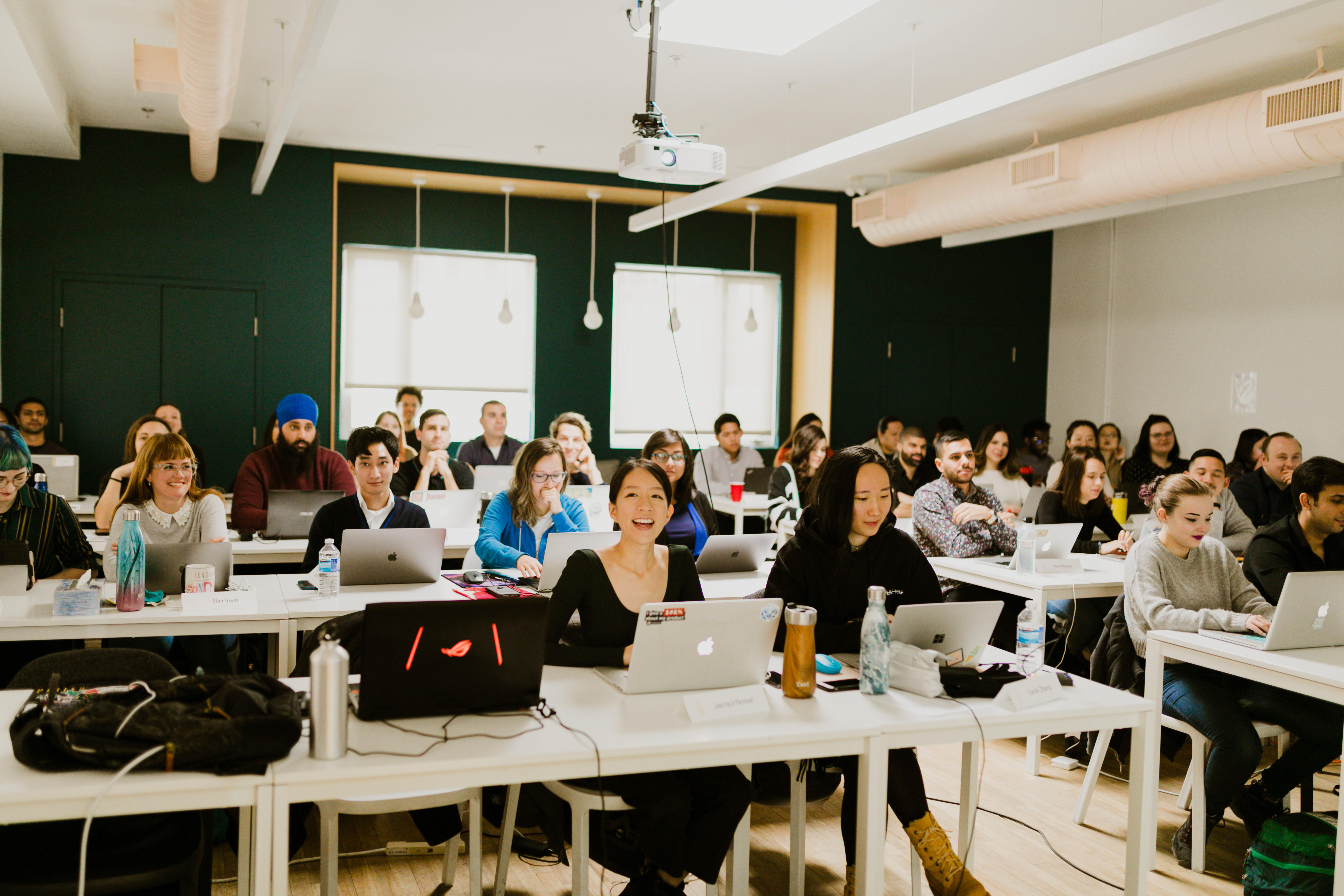 Students smiling in a classroom at Juno