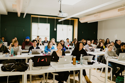 Students smiling in a classroom at Juno