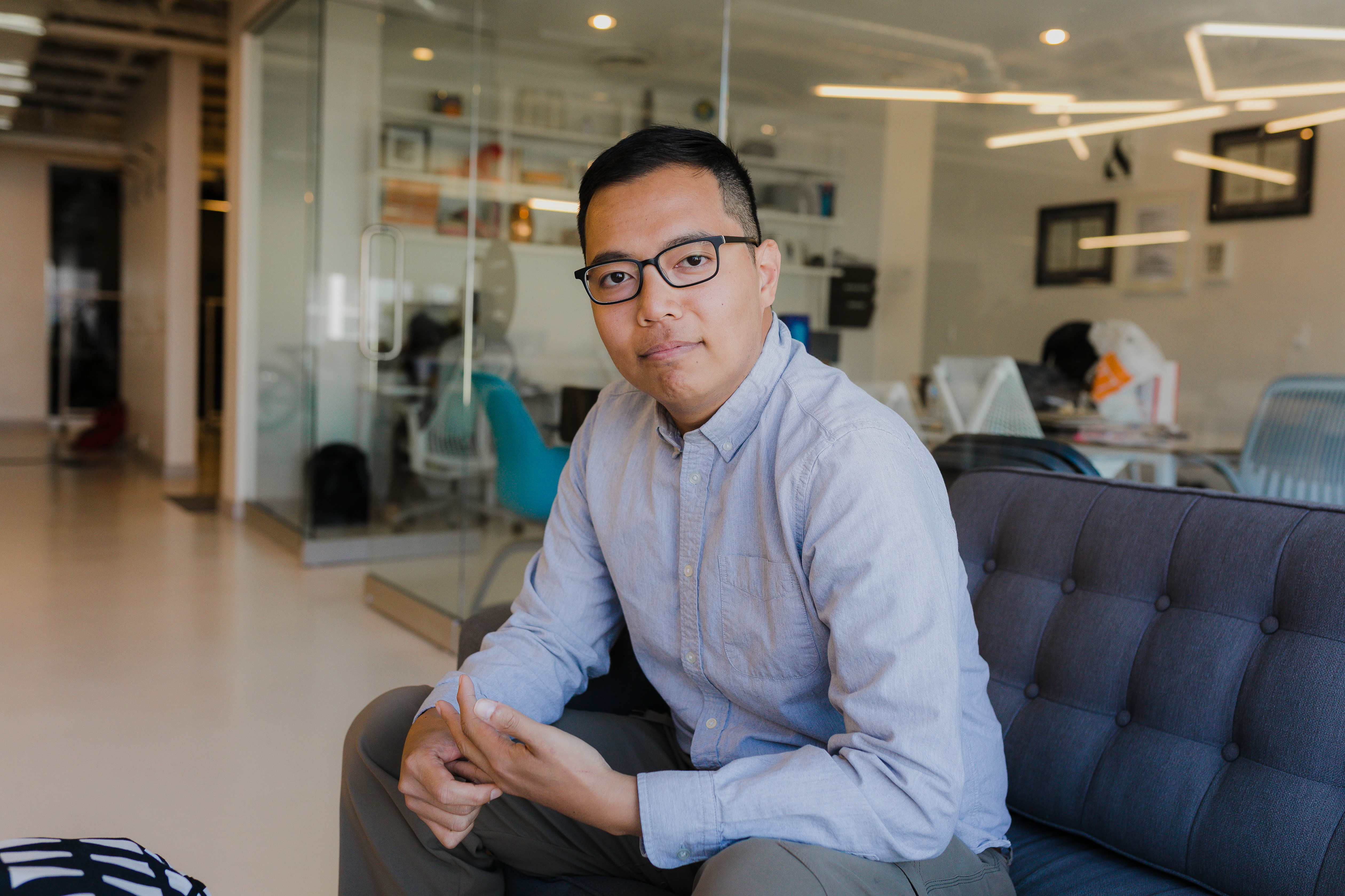 Miguel Bautista sitting at a cough in Juno's co-working space Coral.