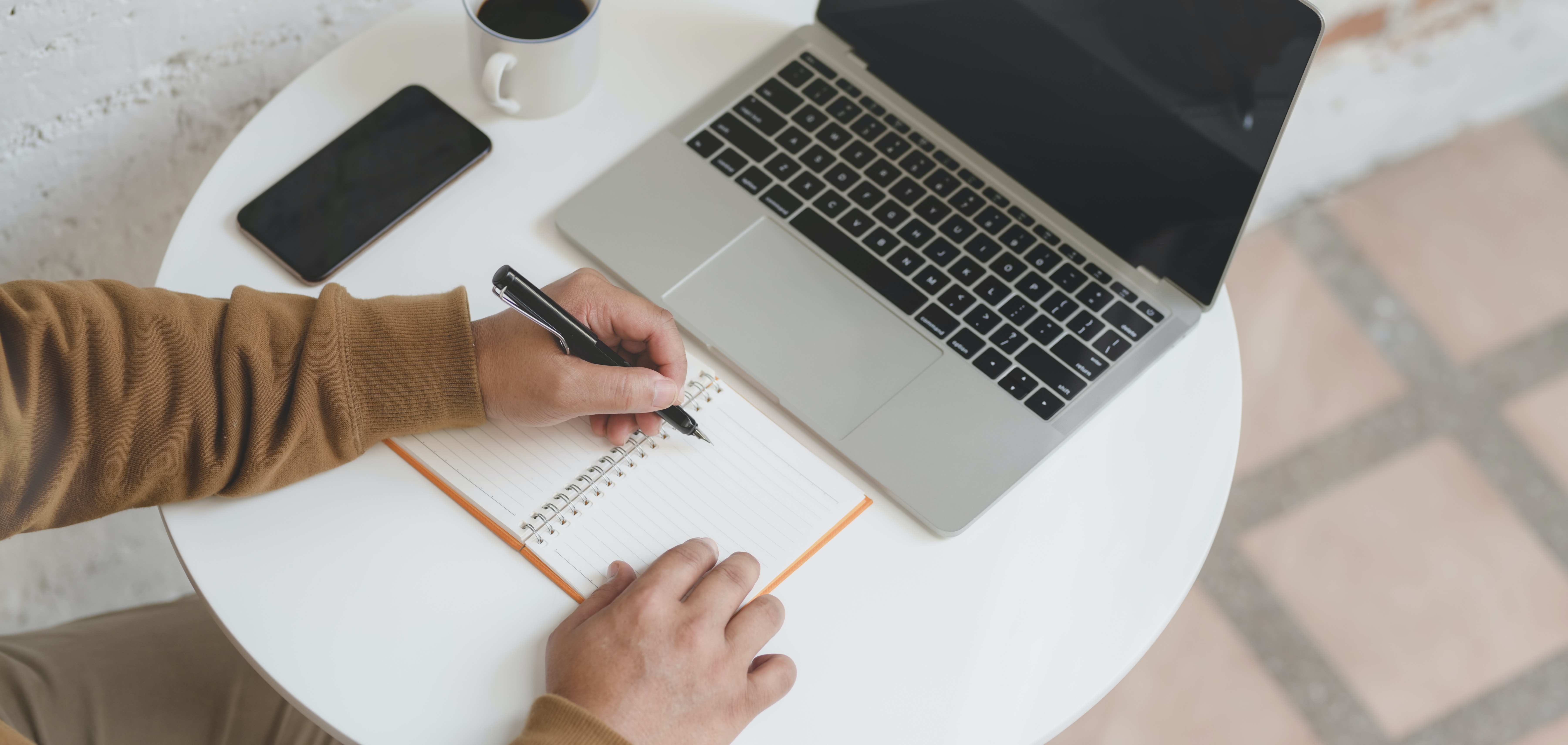 Coffee, notebook, and laptop