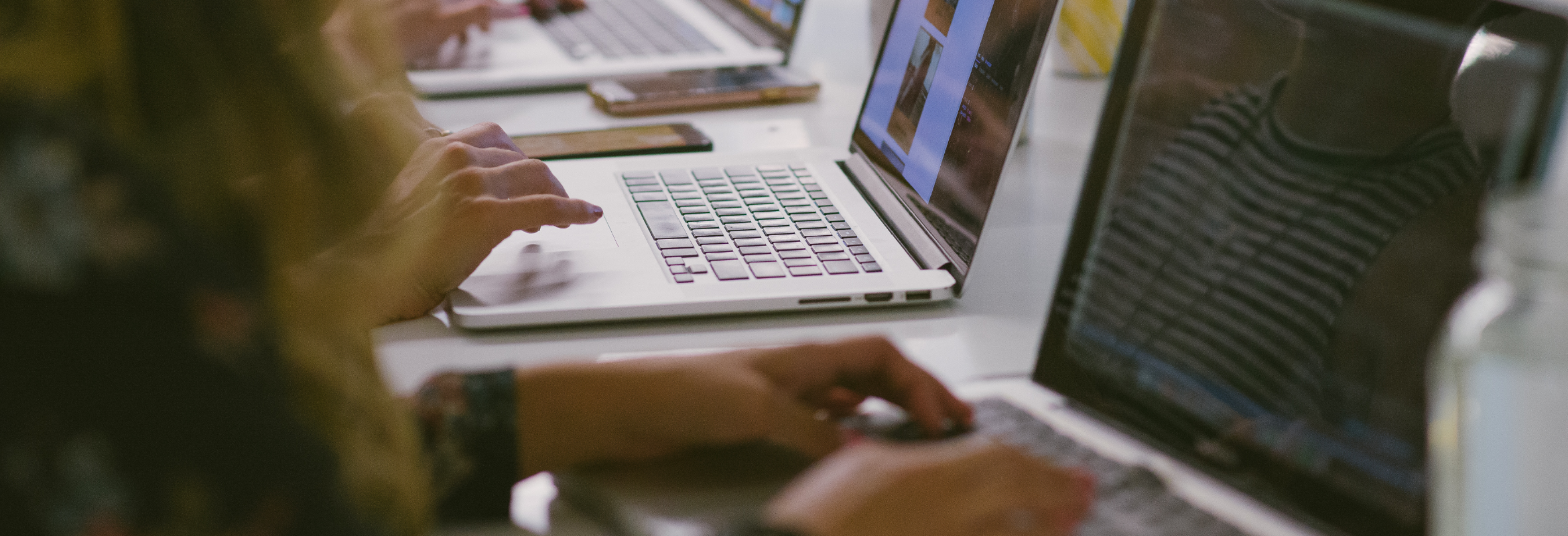 People typing at HackerYou