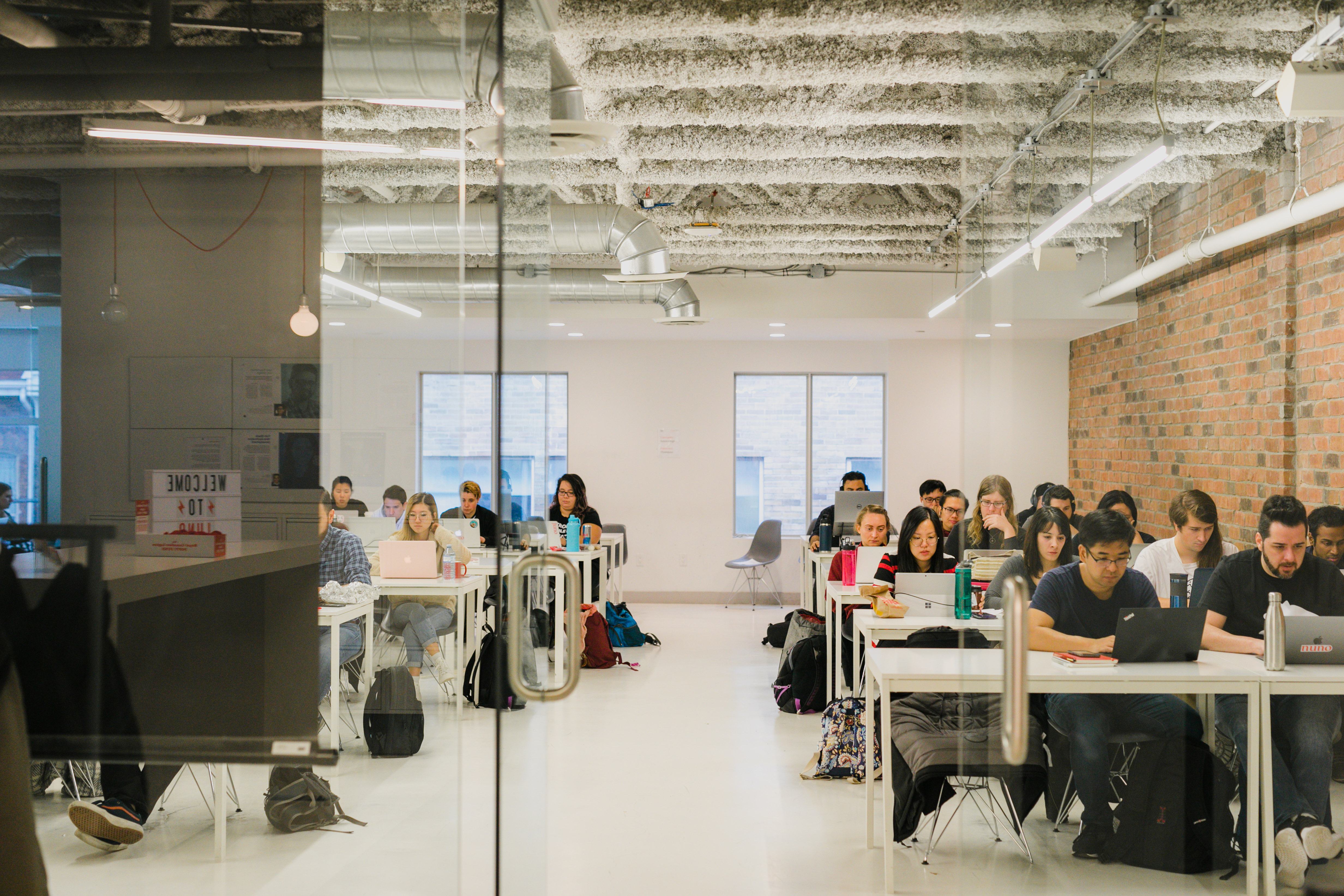 Classroom with students looking down at their laptops 