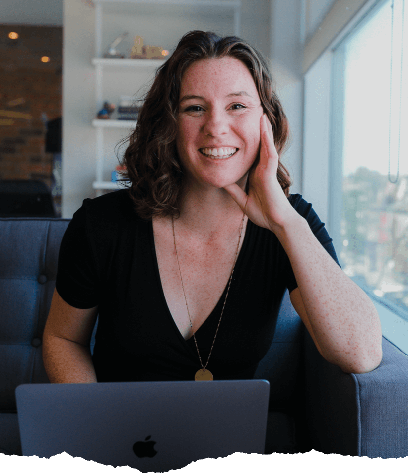 A person on a computer smiles in the Juno campus in Toronto.