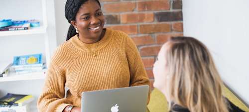 Juno College's Director of Outcomes, Chi-Chi Egbo, meeting with a student.