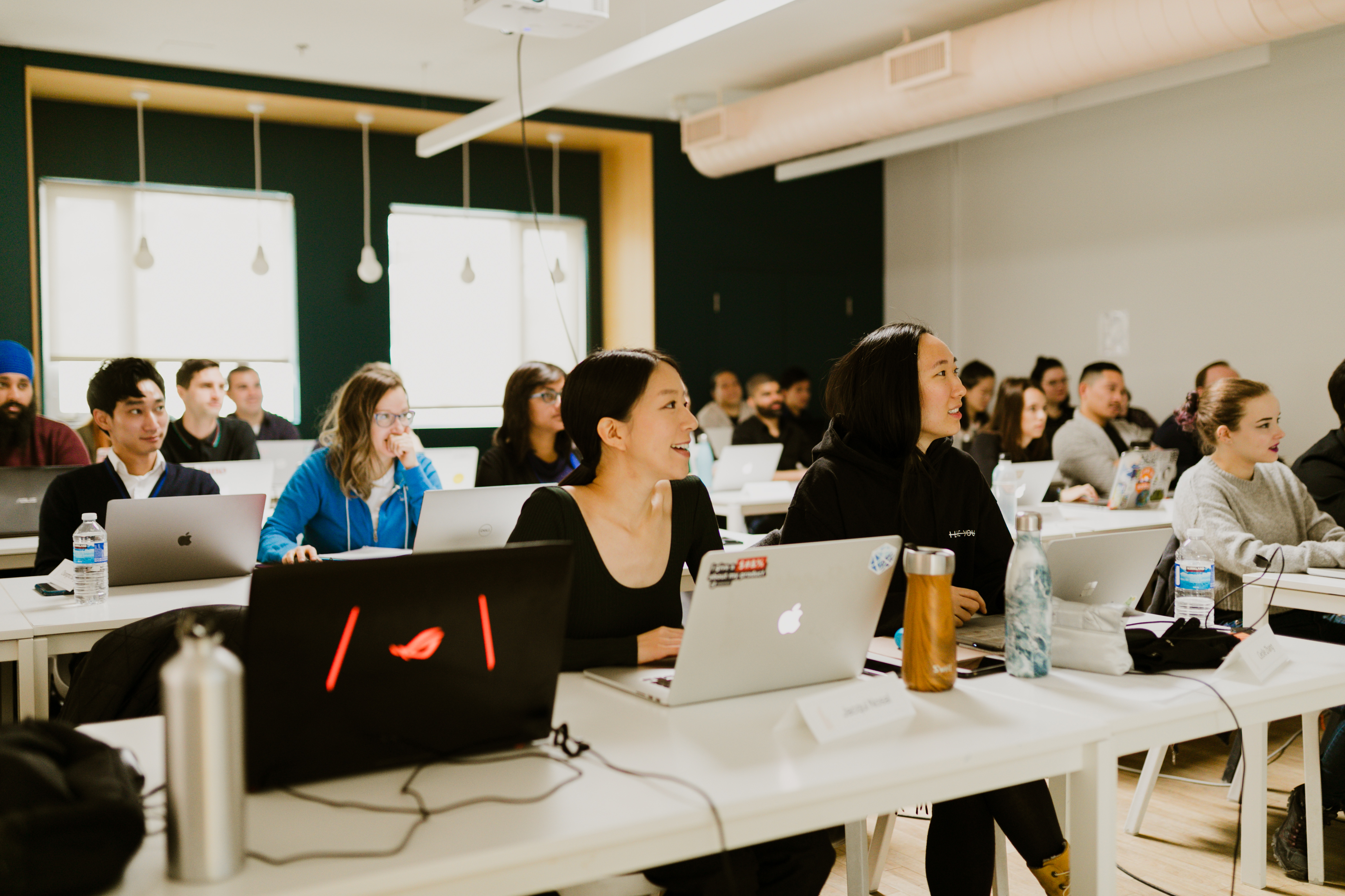 Students happily sitting in a classroom and learning.