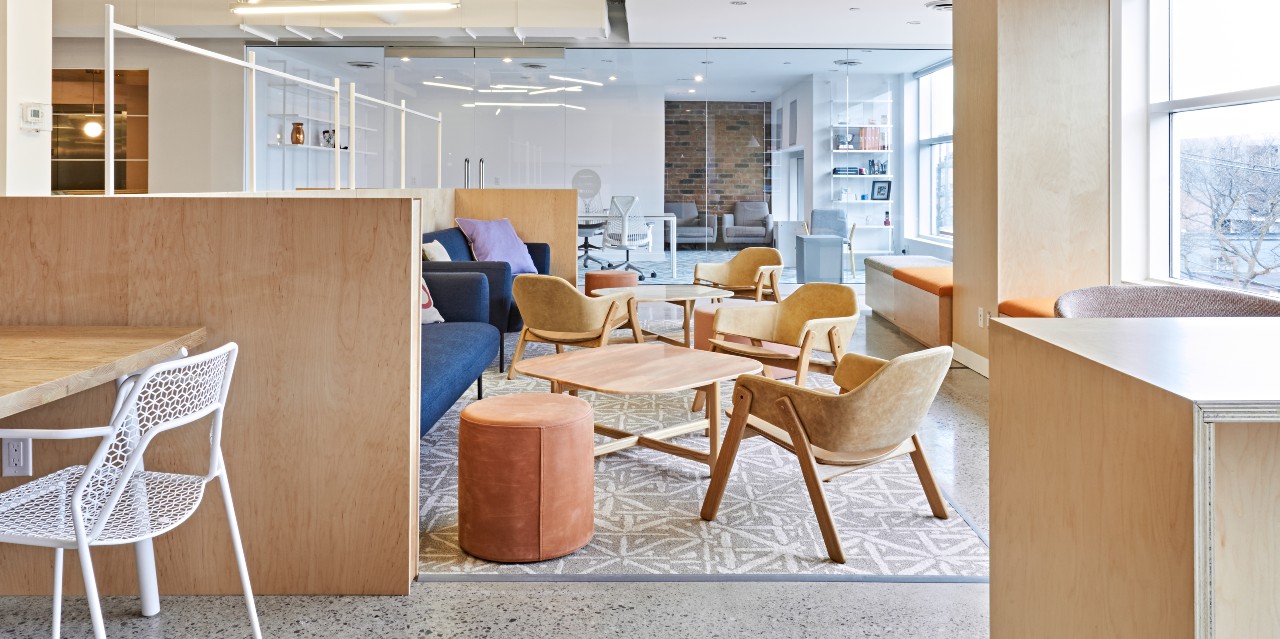 Coral, a coworking and community space in Toronto: a brightly-lit seating area with couches, chairs, and tables