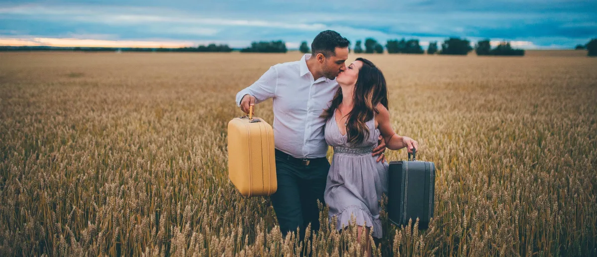 Siya Zarrabi and Kristen Jacobsen kissing in a field.