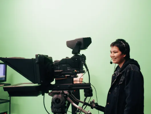 Career Trek participant, Keri-Lynn Readhead, standing behind a television studio camera