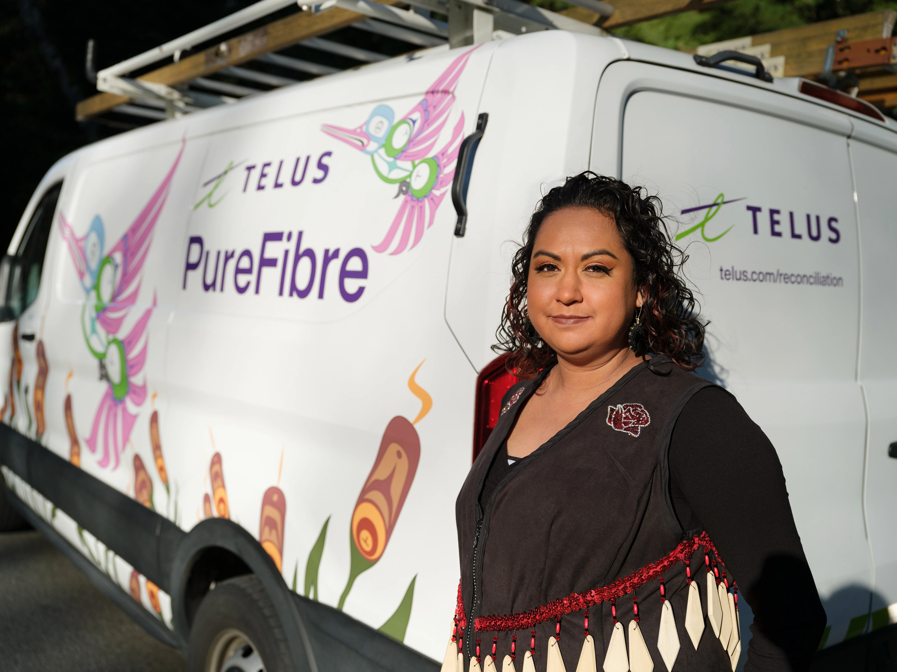 Deanna-Marie Point in front of a TELUS PureFibre van
