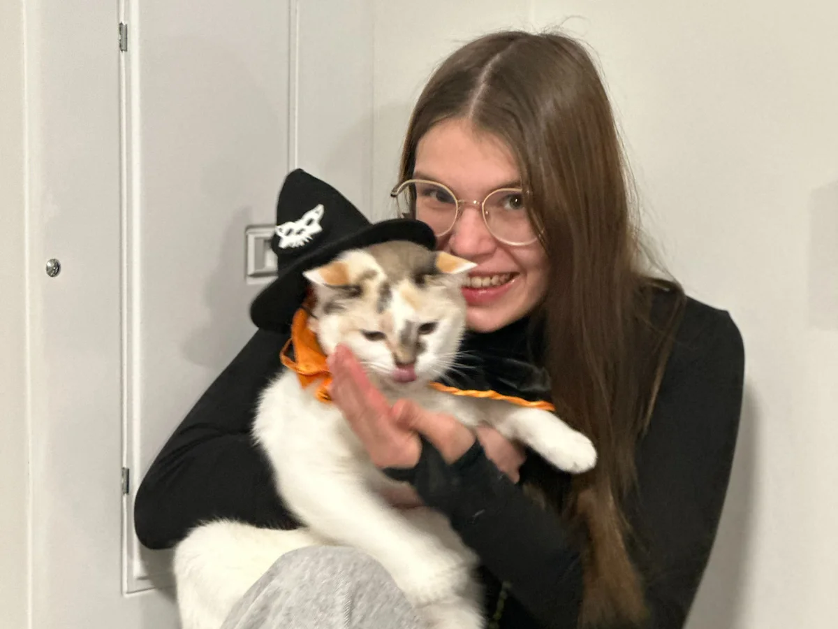 Marilou Landry, a recipient of the TELUS Student Bursary, playing with her cat. 

