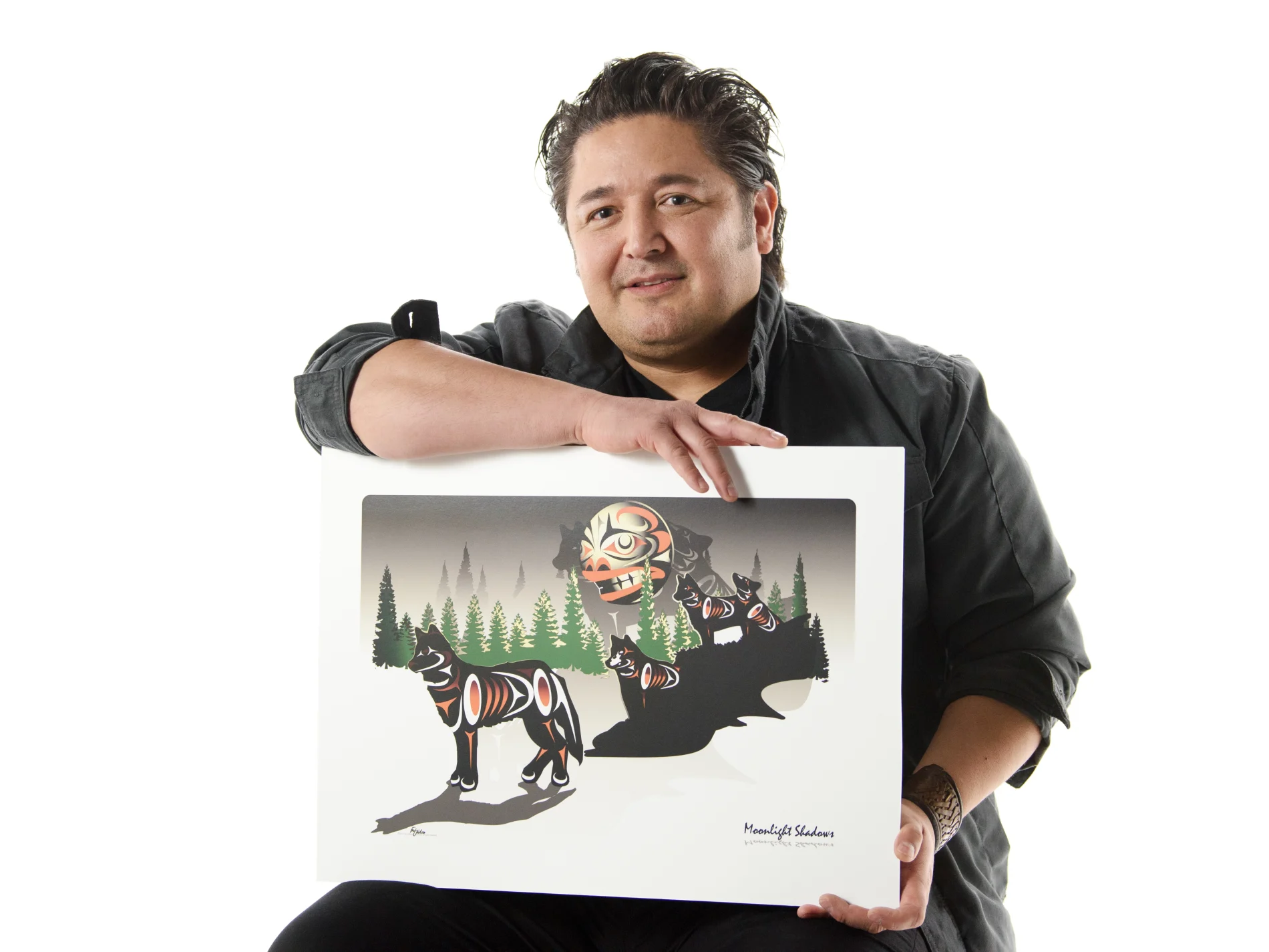 A man holding his indigenous artwork