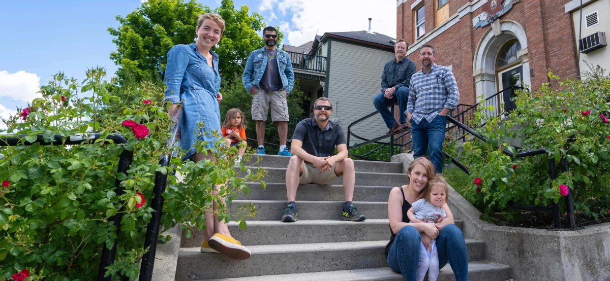 The Traction on Demand team sitting on the steps of their office in Nelson, BC.