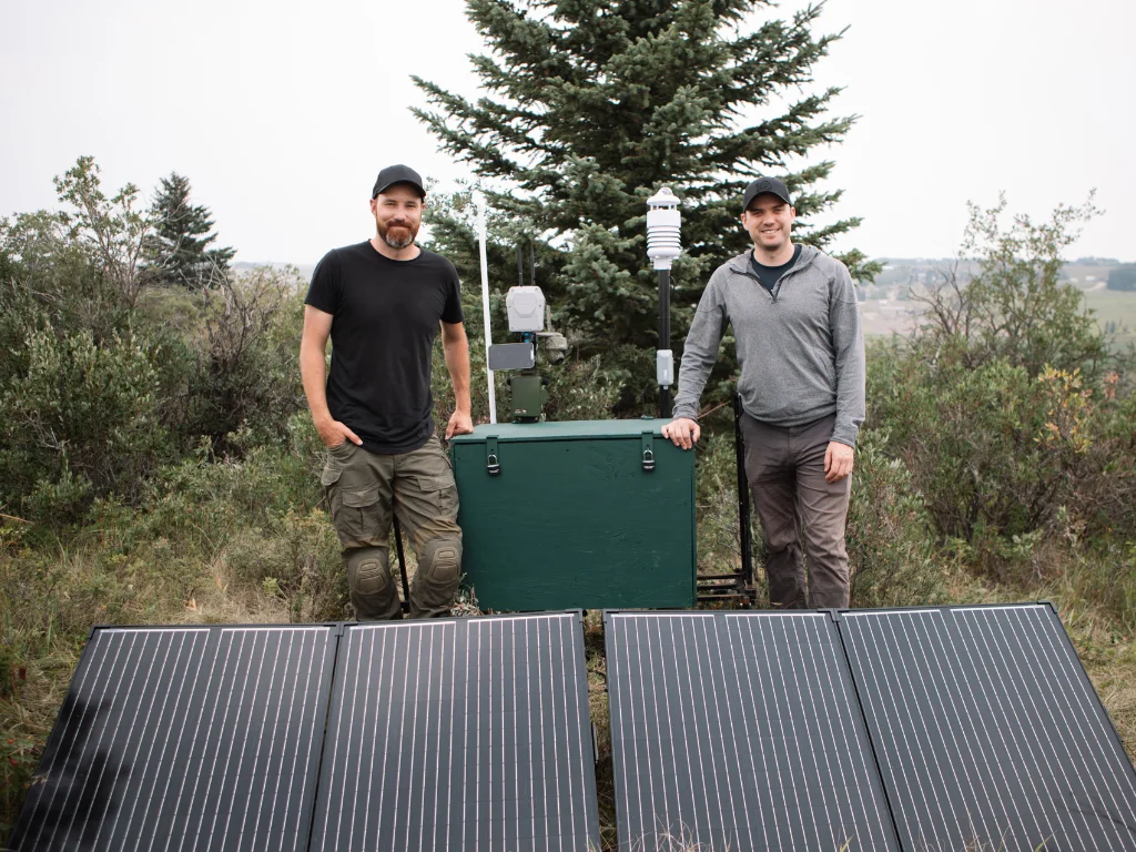 veritree Co-Founder and Director of Innovation, Stephen Emsley, and TELUS Technology Strategy Manager, Devin Gannon, stand next to the ROOT (Realtime Observation Of Trees) System.