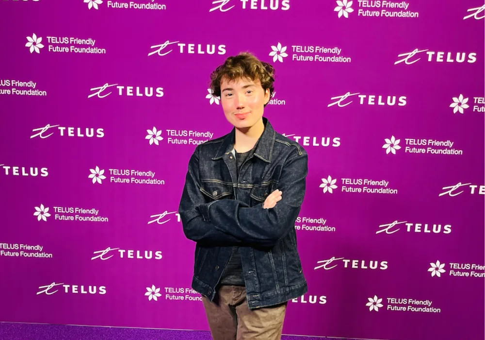 Picture of James in front of a TELUS Friendly Future Foundation backdrop