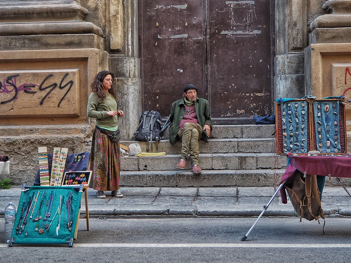 A pair of hawkers outside the steps of a church somewhere in Portugal