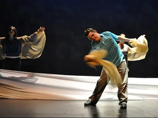 Two dancers using sheets as props in their dance